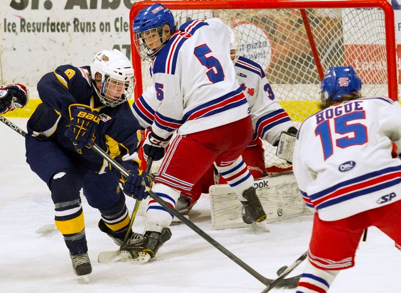 RAIDERS BUFFALOED &#8211; Dan Huculak of the St. Albert Raiders attempts a backhander in traffic against the Calgary Buffaloes in Sunday&#8217;s midget AAA game at Akinsdale