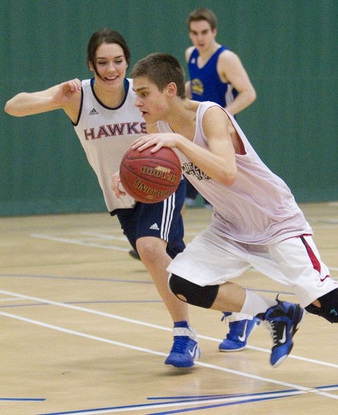 SKYHAWKS SCRIMMAGE &#8211; Dayn Scaber pushes forward with the ball against defender Paige Knull during Wednesday&#8217;s joint practice session for the St. Albert Skyhawks