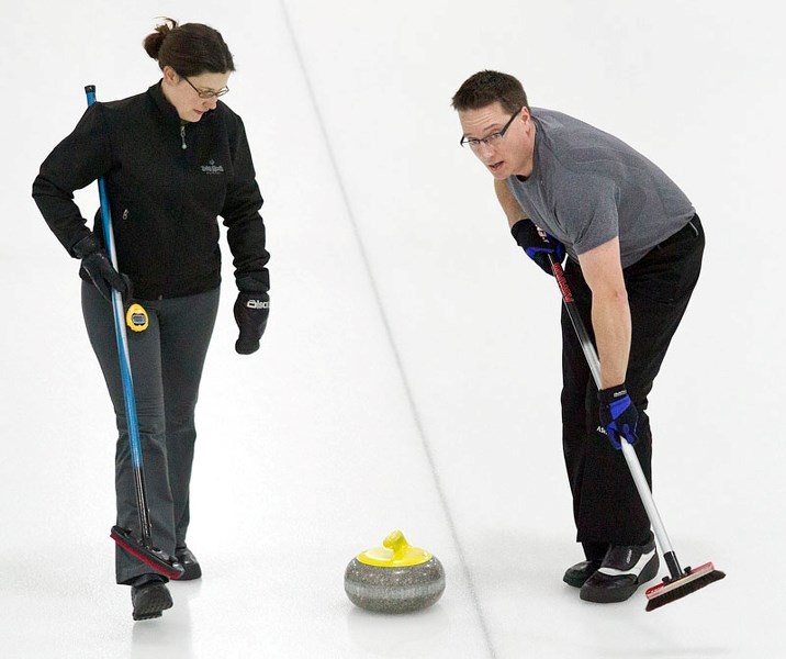 SMOOTH SAILING &#8211; Heather Steele and Warren Cross escort the rock down the ice for the Dean Darwent rink in the Solo Liquor Mixed Bonspiel final Sunday at the St. Albert 