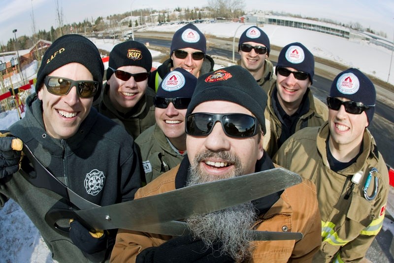 FOR THE CAUSE – Firefighters kick off the third annual Rooftop Campout to raise money for muscular dystrophy. Joining the group of seven is Classic Rock K-97 radio host Steve 