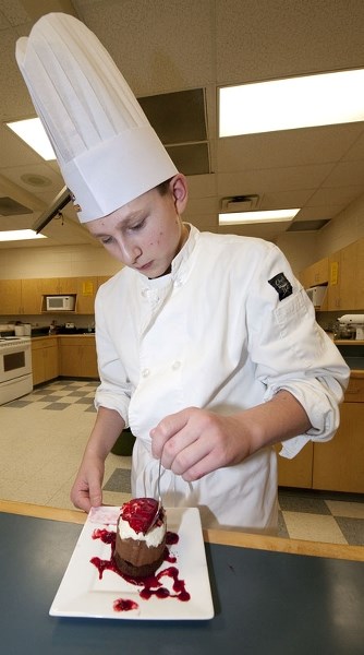COOKING CHALLENGE – St. Albert Catholic High student Luke Cupelli puts the finishing touch on a chocolate mousse he and his teammates will make this weekend as part of the