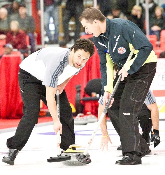 READY TO ROCK &#8211; Scott Pfeifer (left) and Blake MacDonald of the Jamie King rink wait for sweeping instructions on a rock thrown by Jeff Erickson at the Boston Pizza Cup 