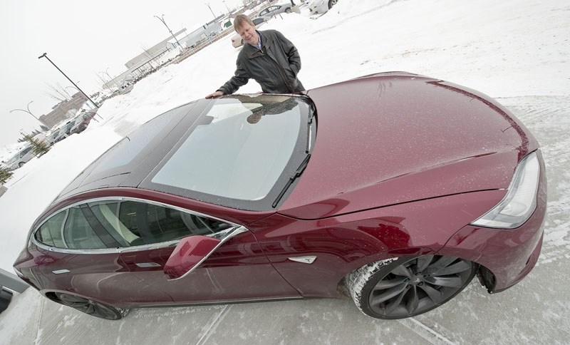 COOL CAR – Alberco president Ron Simonsmeier poses with his Tesla Model S electric car. He believes it to be the first of its kind on the road in Alberta. Simonsmeier