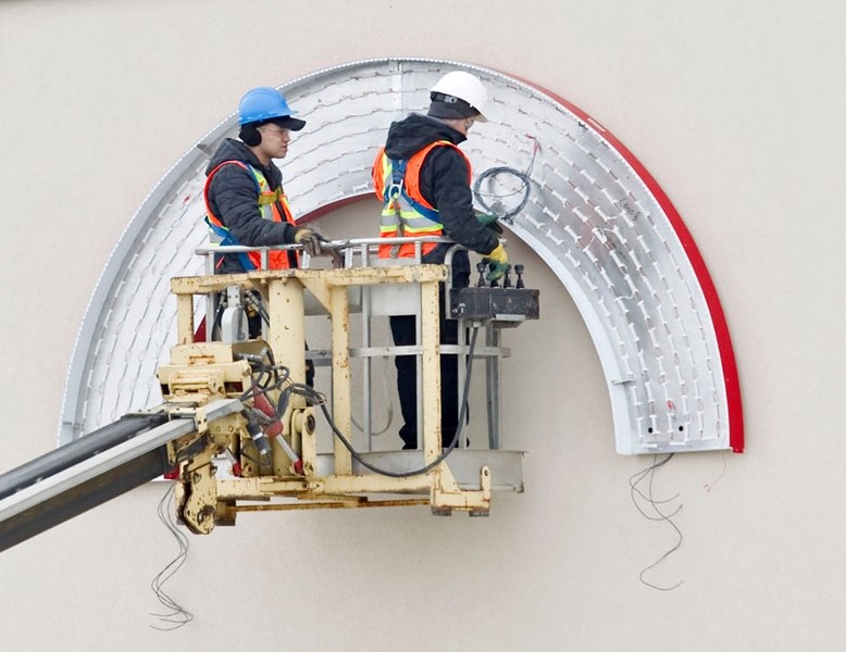 OPENING SOON – Workers this month were installing the outdoor sign that will be the distinctive Target logo. The store is conducting hiring interviews this week with a view