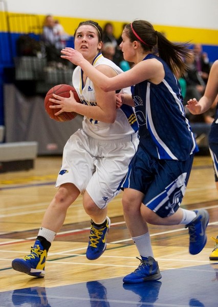 LOOKING TO SCORE &#8211; Paige Knull of the St. Albert Skyhawks eyes up the basket while guarded by Tiana Woyewitka of the Paul Kane Blues in Wednesday&#8217;s metro Edmonton 