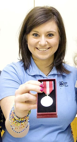 SHINY HARDWARE – Amanda Magyar (centre) displays the Queen&#8217;s Diamond Jubilee Medal she received for her volunteer work with the Girl Guides of Canada.