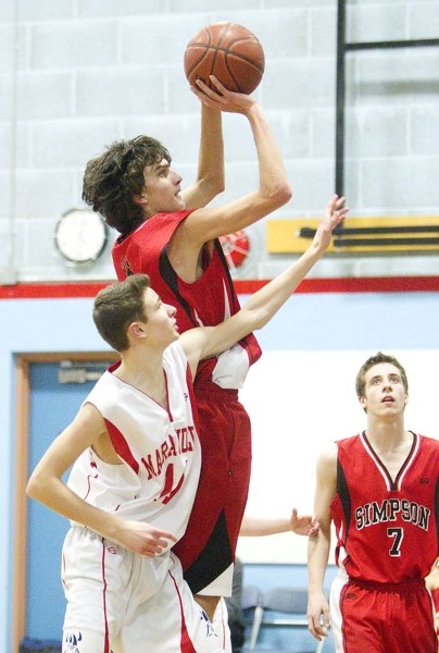 SHOOTING FOR POINTS &#8211; Mickey Khan of the Sir George Simpson Voyageurs goes up for a shot against Sean Battiston of the Vincent J. Maloney Marauders on Tuesday in the