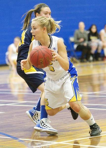 BUSTING A MOVE &#8211; Abby Schneider of the St. Albert Skyhawks drives past a Bev Facey defender in Tuesday&#8217;s metro Edmonton premier junior semifinal at the SkyDome.