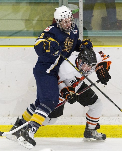 ROUGH PLAY &#8211; Zack Gonek of the St. Albert Raiders gets physical with a Lloydminster Bobcat in game three in the best-of-five midget AAA north division semifinal at