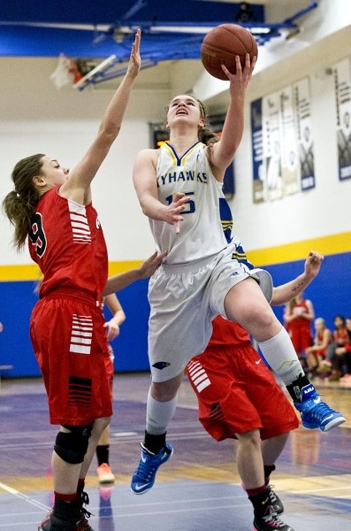 LEAP OF FAITH – Marinya Marcichiw of the St. Albert Skyhawks soars to the hoop against Jocelyn Algeo of the Jasper Place Rebels in Wednesday&#8217;s metro Edmonton division