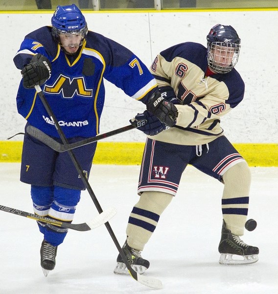 PLAYOFF BATTLE &#8211; Blair Macuch of the St. Albert Merchants pushes his way past Ben Fonteyne of the Wetaskiwin Icemen in Wednesday&#8217;s junior B semifinal opener at