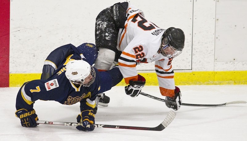 BENT OUT OF SHAPE &#8211; Matt Maetche (left) of the St. Albert Raiders and Cole Nicholson of the Lloydminster Bobcats get twisted up during a collision in the midget AAA