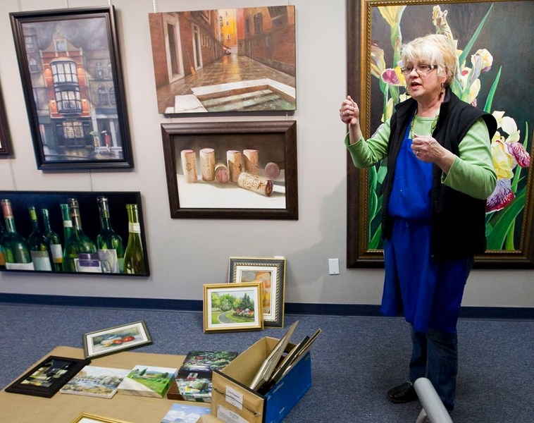 FLOOR PLAN – Laura Watmough of Hidden Talent Fine Arts School and Gallery demonstrates how she plans out an arrangement of paintings by placing them on a piece of paper on