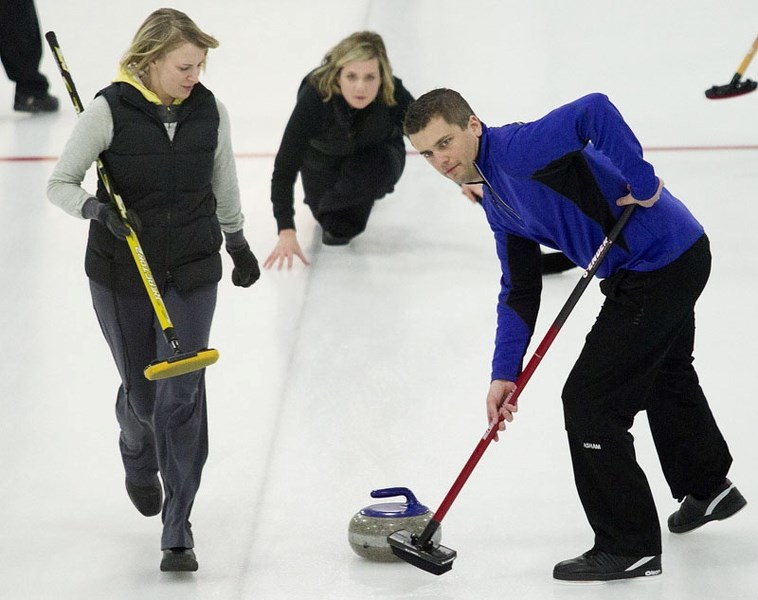 MIXING IT UP &#8211; Tara and Bryan Connell wait for sweeping instructions with Lindsay Schultz&#8217;s rock during the President&#8217;s Cup A-B mixed final Friday at the