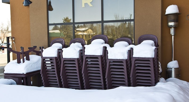 BE PATIENT – These snow-covered chairs at Ric&#8217;s Grill tell the story of St. Albert – winter is leaving us but we won&#8217;t be sipping drinks on the terrace for a few