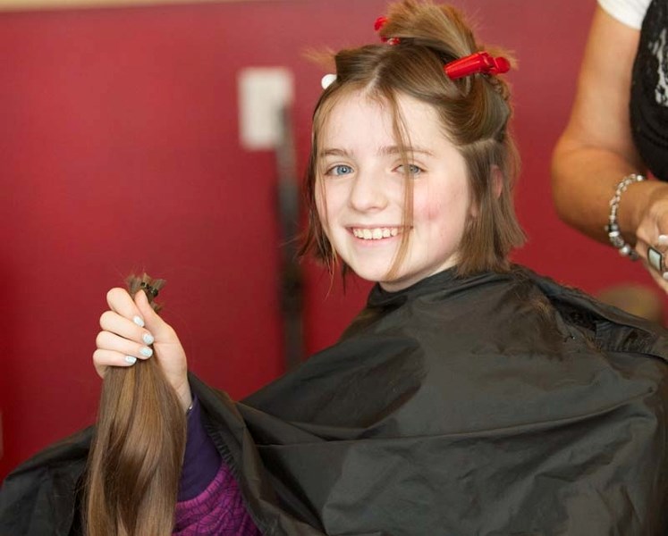 PROUD DONOR – Rachel Kaine proudly holds up the hair that she had cut off on Saturday. This is the fourth year that Kaine has donated her hair so it can be made into a wig