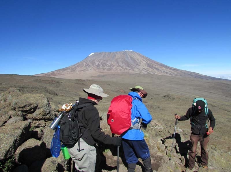 ON THE MOUNTAIN – Lo-Se-Ca bus driver Mary Winkleman (left) and client Dan Huising hike at Mt. Kilimanjaro along with one of the group&#8217;s guides.