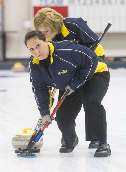 CITY PLAYOFFS &#8211; Kathy Piper (front) and Laurie Schreiner work the ice for the Christina Monk rink of St. Albert in Thursday&#8217;s A-event qualifier against the