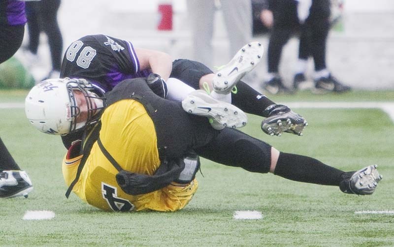 TAKEDOWN &#8211; Graeme Loerke of the St. Albert Storm pins an Edmonton Charger into the turf in Friday&#8217;s midget spring league game at Riel Recreation Park. The