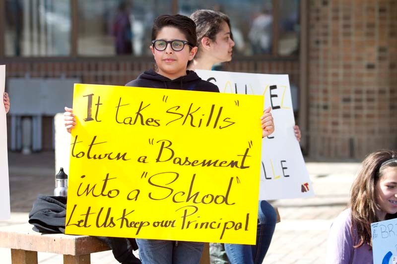 YOUNG ACTIVISTS – Brandon Azer of école Alexandre Taché stands outside St. Albert Place on Friday morning protesting the firing of the school&#8217;s principal