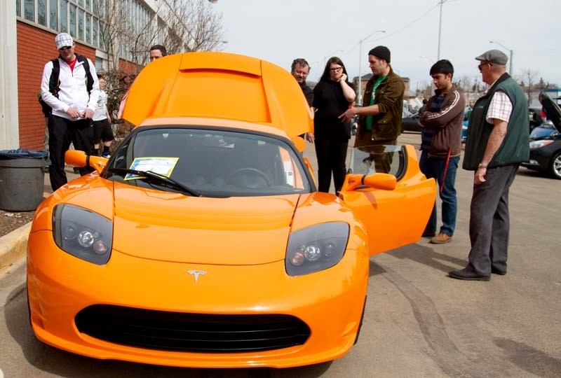 BATTERY POWERED &#8211; A crowd forms around a 2010 Tesla Roadster at the Future of Transportation symposium on Saturday at NAIT.