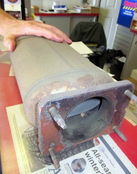 CRIMINAL COMMODITY – Tirecraft assistant manager Don Maier shows an old catalytic converter. The platinum inside is worth about $100.