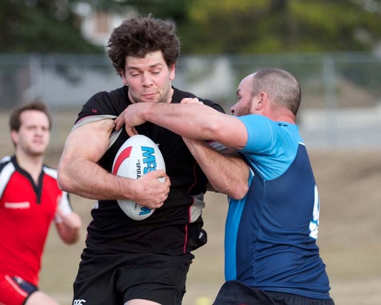 TRAINING TO WIN &#8211; Adam Bontus absorbs a high tackle from Aaron Millard during Thursday&#8217;s training session at the Wild Rose Elementary School field. The St. Albert 