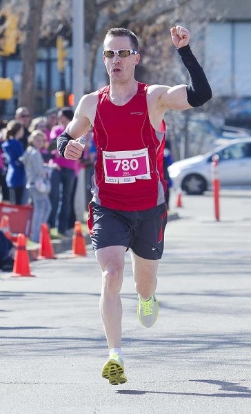DEFENDING CHAMPION &#8211; Marc Meunier of St. Albert celebrates his repeat victory at the Leading Edge RunWild Marathon last year. The third annual RunWild starts 8 a.m.
