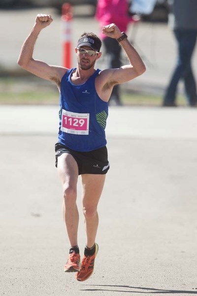 MARATHON MAN &#8211; Caine Warburton pumps his fists in celebration while approaching the finish line on victory lane at the third annual Leading Edge RunWild Marathon on