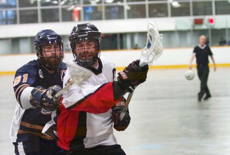 FLYING OBJECT &#8211; St. Albert Miners captain Nate Schmidt and Edmonton Outlaws captain Matt Dilts battle for the ball in Friday&#8217;s senior B season opener in the Rocky 