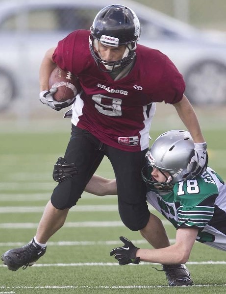 DAWG ON THE RUN &#8211; Bellerose Bulldogs running back Tyler Thorsley tries to escape a tackle in Thursday&#8217;s exhibition (no special teams) against the Austin