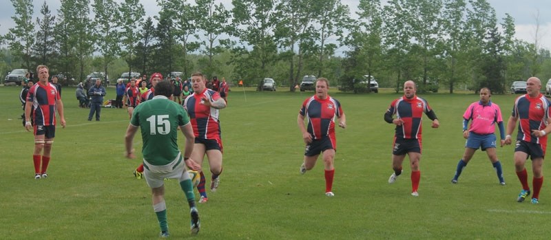 DEFENSIVE LINE &#8211; Nick Dragich attempts to block the kick by the Calgary Irish fullback as the defensive line of the St. Albert premier men&#8217;s team charges forward
