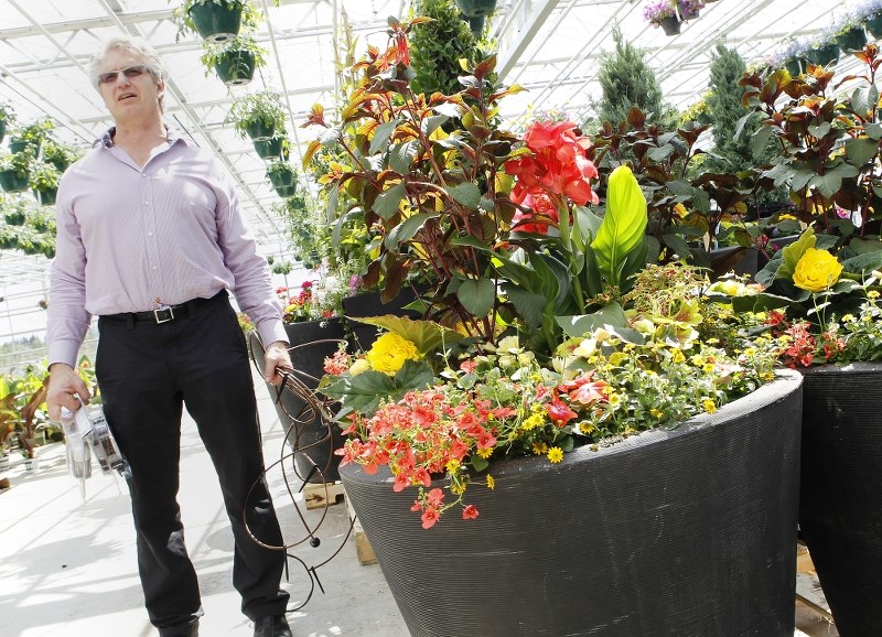 SIZE MATTERS – Jim Hole explains that large outdoor flower pots are easier to keep watered than smaller containers.