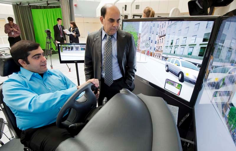 UNSAFE – University of Alberta graduate student Mayank Rehani (seated) discusses the results of a driving simulator test with supervising professor Yagesh Bhambhani at the