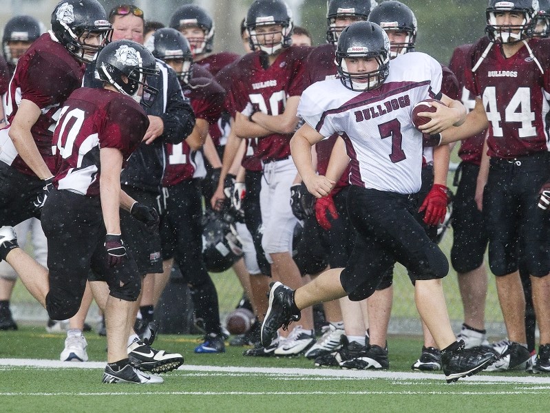 DAWG BOWL &#8211; Bellerose Bulldogs quarterback Matty Short breaks away from defensive back Mark Warwa for an 80-yard touchdown run in the second quarter for Team Rose in