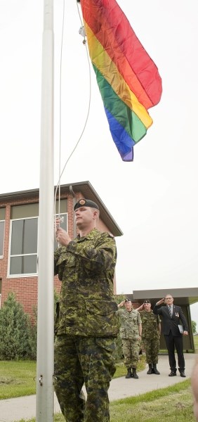 SOLDIER&#8217;S PRIDE — Pvt. Darren McCausland raises a rainbow-coloured flag to commemorate Pride Week on the Edmonton Garrison Friday. It was the first time that the event