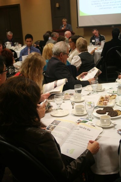 YEAR IN REVIEW – Chamber of Commerce members reviewed the year in review document Wednesday at the luncheon
