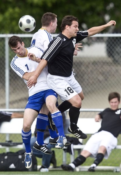 AIRBORNE &#8211; St. Albert Impact players Jeff Bruha (front) and Ciaran Thompson jump to head the ball against the DV Oldboys in Thursday&#8217;s premier men&#8217;s match