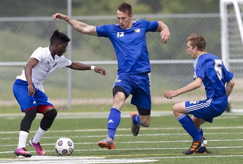 CHALLENGE PLAY &#8211; Andy Tardiff (middle) of the St. Albert Impact premier team and U16 Impact Tier I callup Dan Sperling pressure Hanson Boakai of the FC Edmonton