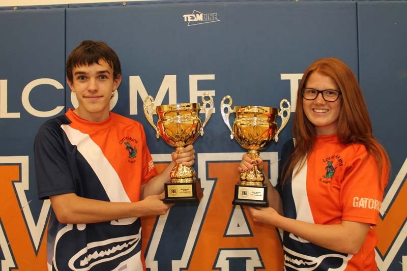 GATORS REPEAT &#8211; Telly Gurney and Emily Dewitt display the Greater Edmonton junior high 7&#8217;s flag rugby championship trophies the Lorne Akins Gators&#8217; male and 