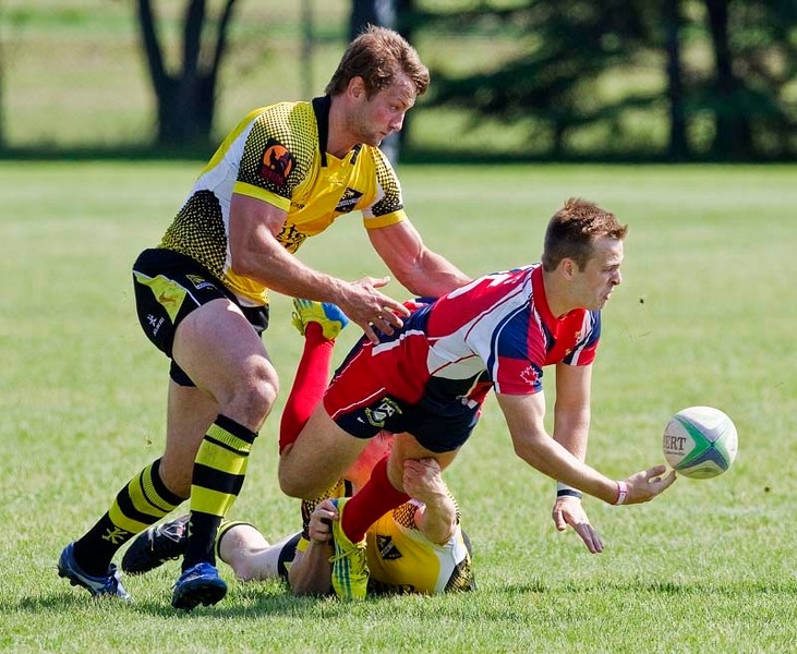 TAKEDOWN &#8211; Antony Fitch of St. Albert releases the ball while tackled to the pitch by the Calgary Hornets in Saturday&#8217;s premier men&#8217;s rugby match. The