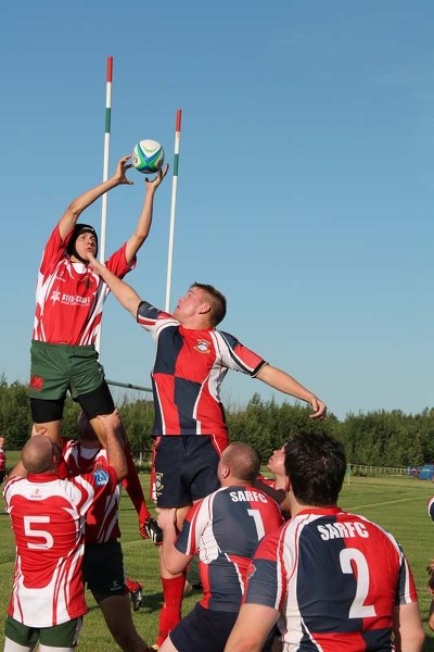 UP IN THE AIR &#8211; The Strathcona Druids win a lineout ball against St. Albert jumper Trent Bennett
