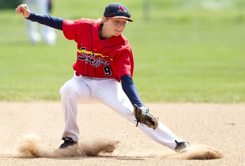 IN THE DIRT – Tyler Jans tries for the catch on a throw to second base during the first game of a doubleheader between the bantam AAA Cardinals and Okotoks Dawgs Black at