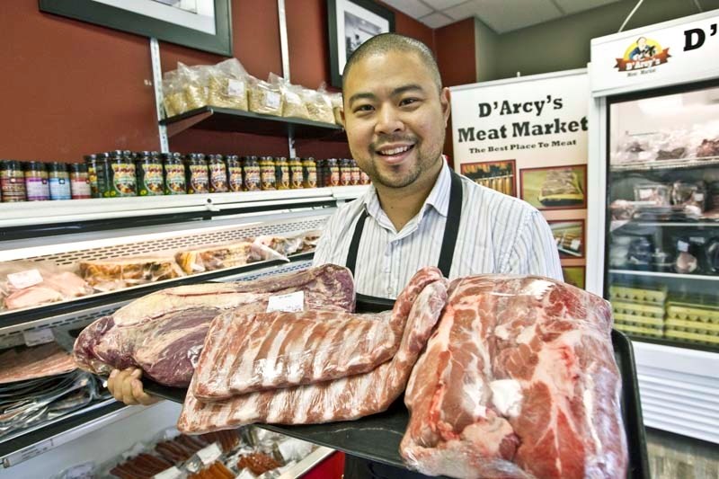 MEAT CHAMPS – George Hong of D&#8217;Arcy&#8217;s Meat Market holds the three most commom cuts of meat people smoke (from left): brisket