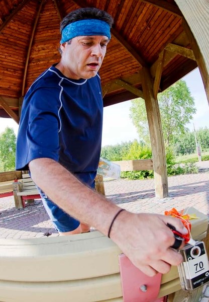 FOUND IT – Chris Sigvaldason of Edmonton swipes his GPS tag during an Orienteering event at Kingswood Park last week.