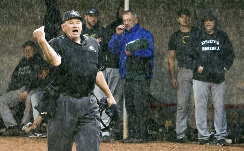 DON&#8217;T PLAY BALL! – A sudden downpour prompts umpire Jeff Donnelly to call the game between Fort Saskatchewan and Confederation Saturday evening at Legion Memorial Park. 
