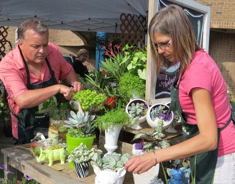PLANT ARTISTS – Randy Cone and Wendy Perowski arrange plants in unique collectibles and antiques. They are in their second year of selling at the St. Albert Farmers&#8217;