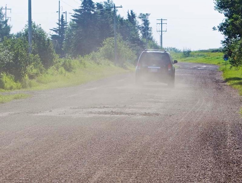 KICKING UP DUST – An SUV travels along Poundmaker Road
