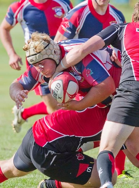 SUDDEN IMPACT &#8211; Angus MacDonald runs into contact against the Calgary Saints in Alberta Cup rugby Saturday in Sherwood Park. St. Albert&#8217;s premier men&#8217;s team 