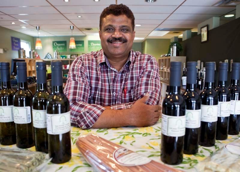 OLIVES AND VINEGAR – Hemant Patel sells a variety of olive oil and balsamic vinegar at his new store